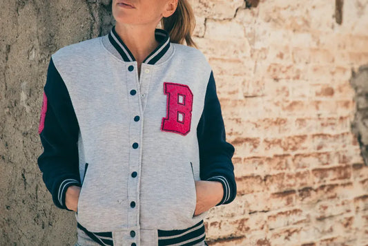 Handmade classic varsity top with gray body, navy sleeves, and pink "B" patch.