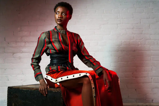 Women's long-sleeve silk blouse with red, black, and white vertical stripes and button details.